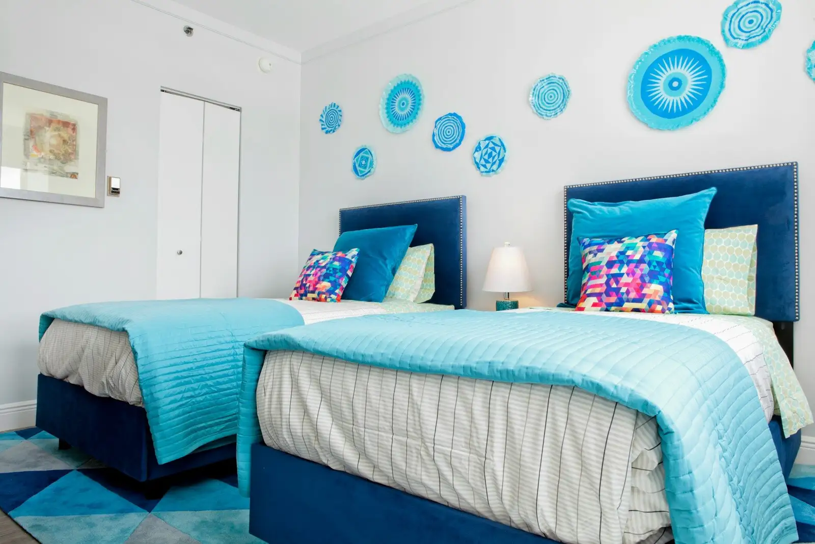Bedroom with two single beds and blue headboards