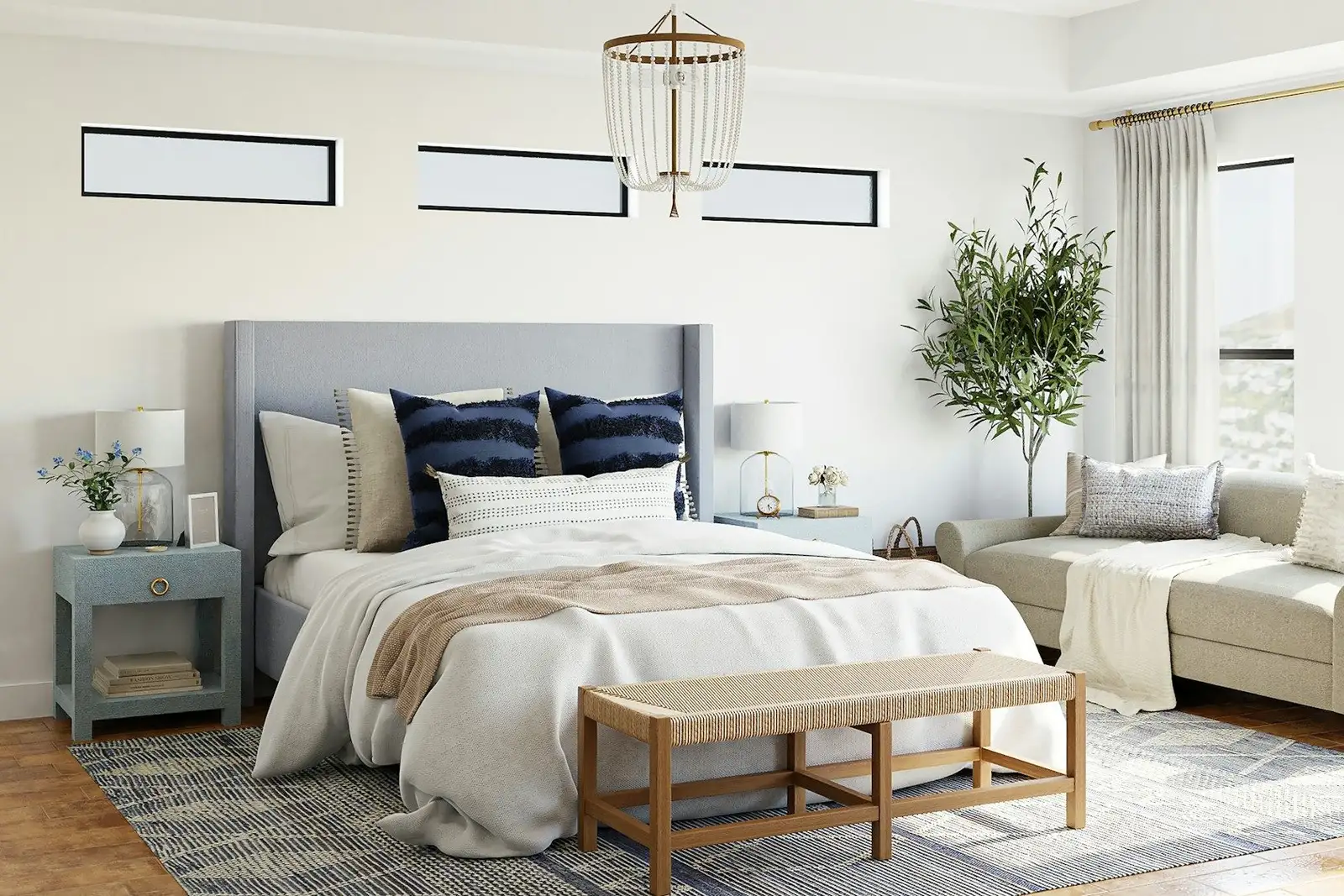 Bedroom with a grey headboard and a sofa by the window