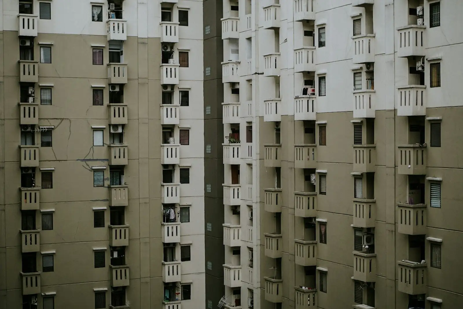 Two residential towers with rows of small balconies