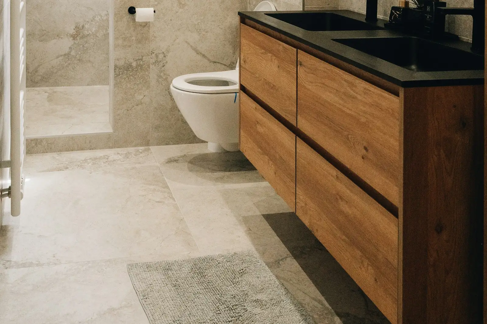 Bathroom with a wooden double vanity and stone tiles