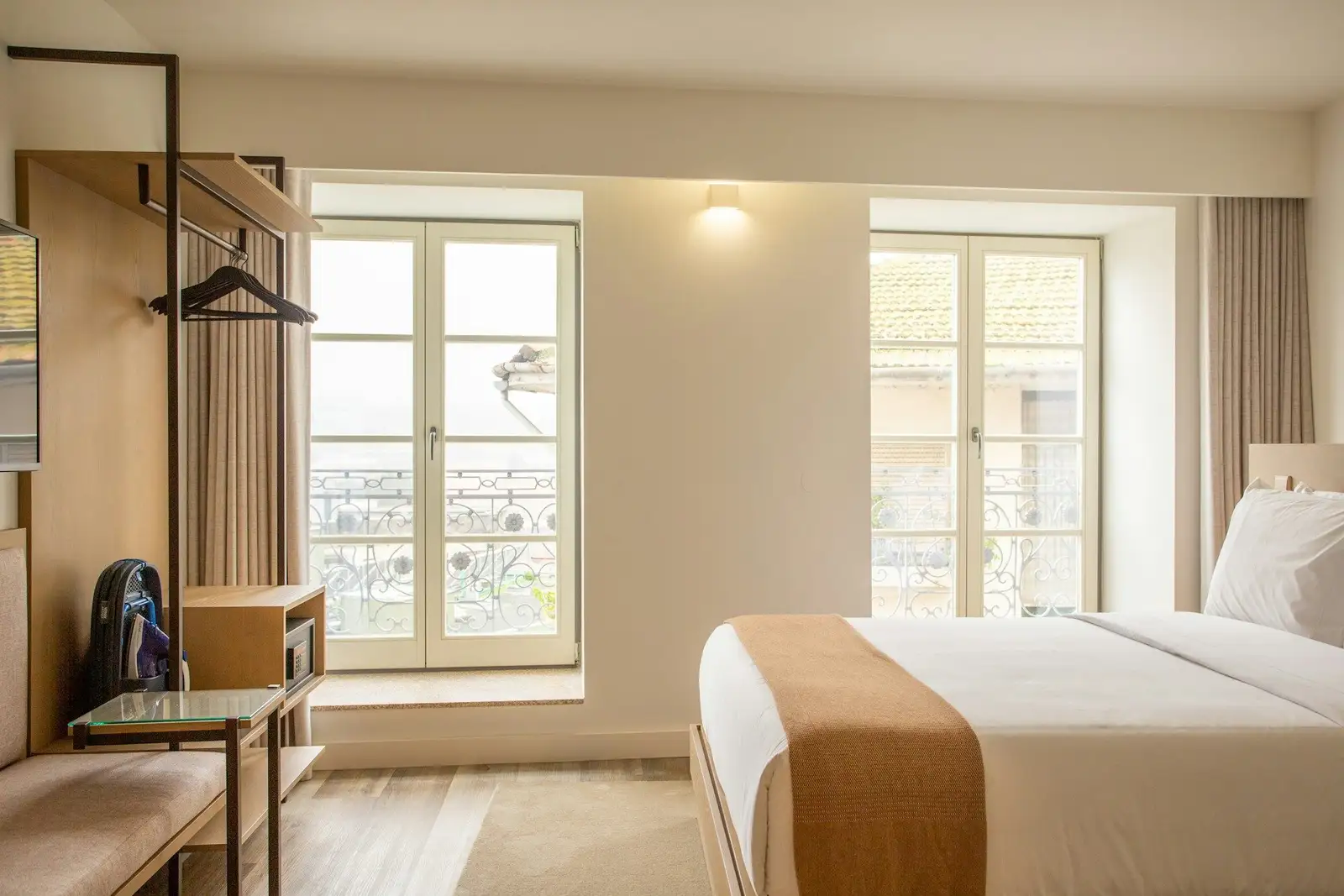 Bedroom with a clothes rail and two tall windows