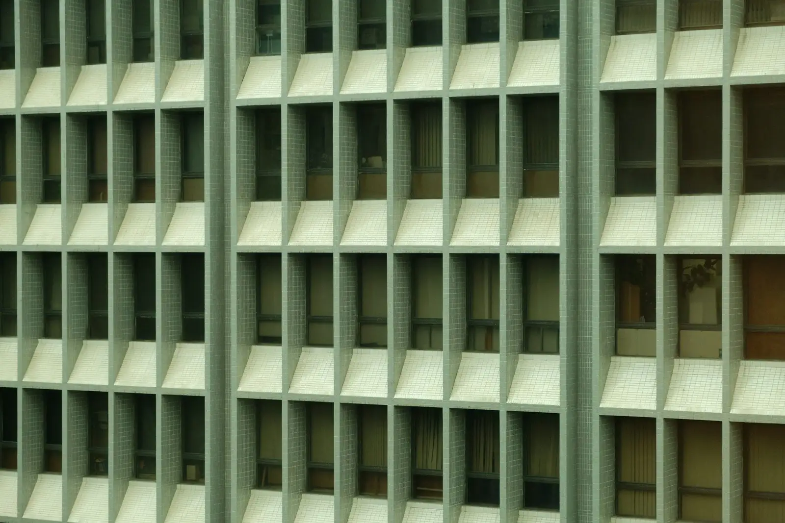 Pale green grid facade of an apartment building