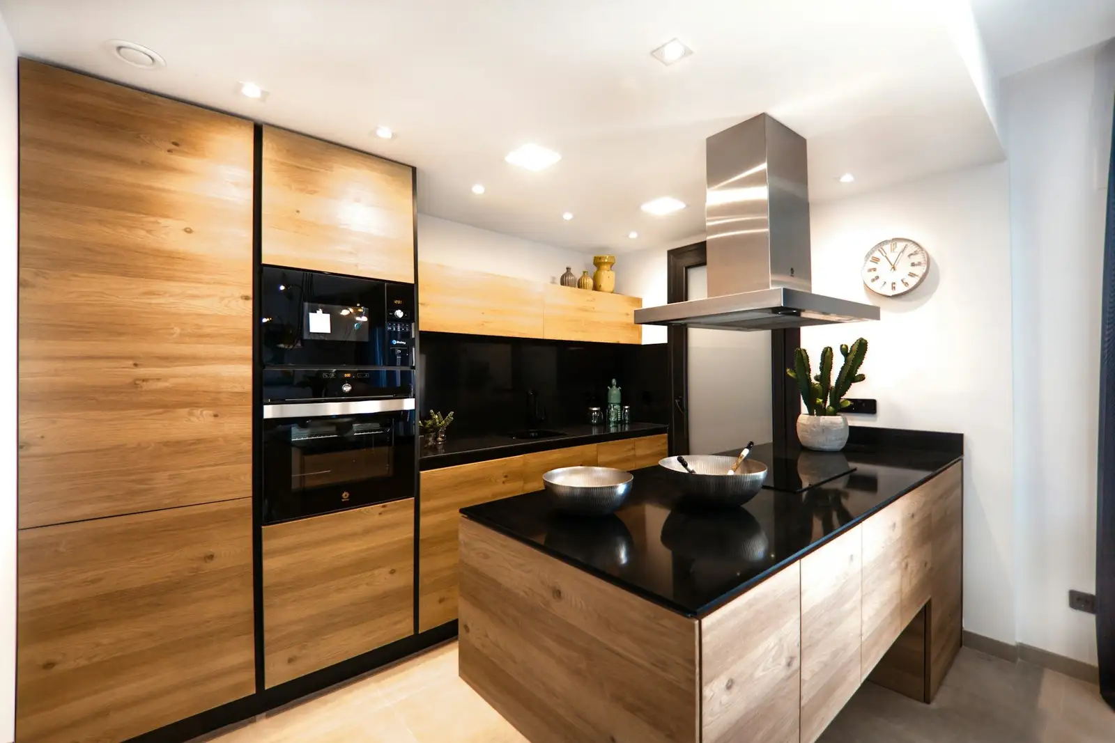 Kitchen with wood-grain cabinets and a black-topped island