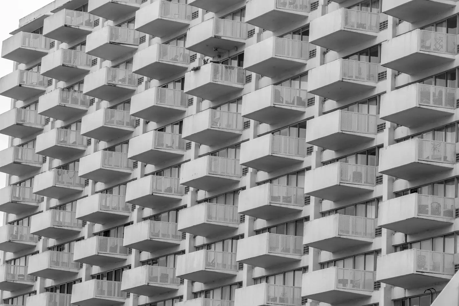 Black-and-white view of a facade lined with balconies