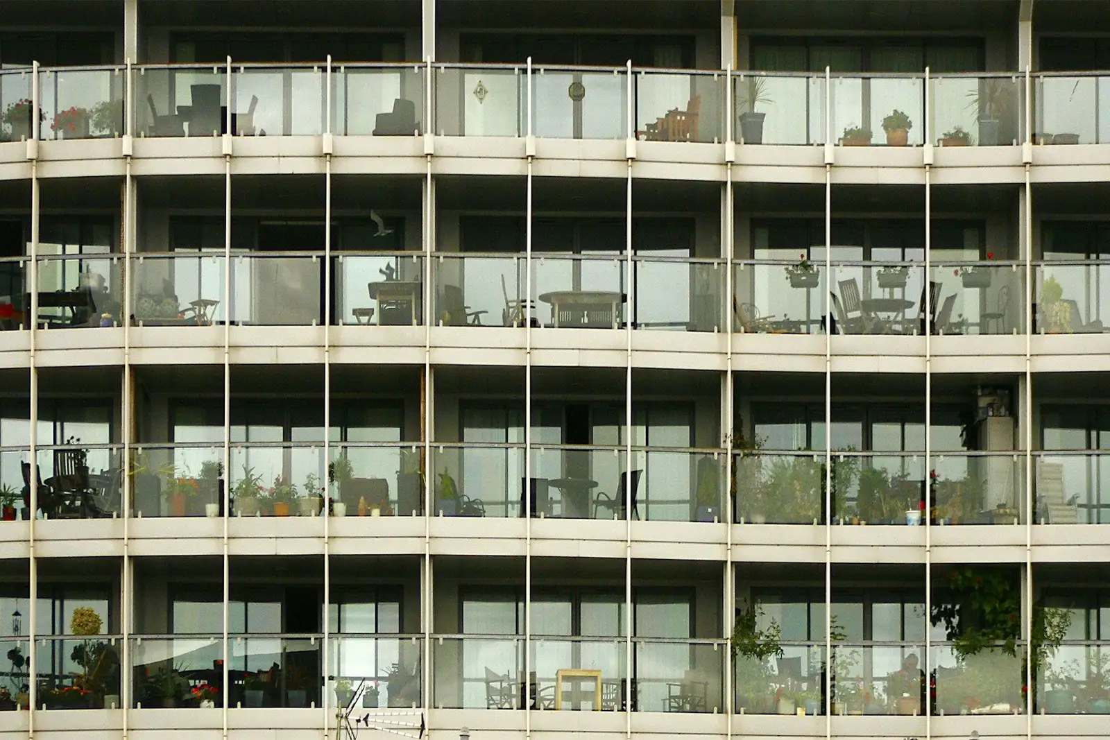 Curved apartment facade with glass balcony railings