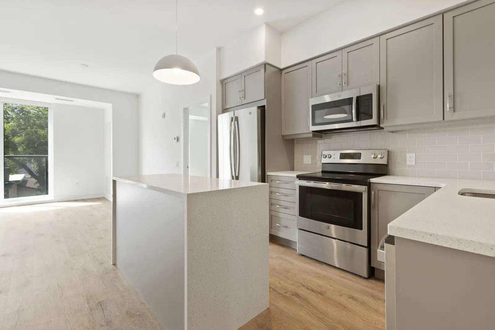 Grey kitchen with an island and stainless appliances